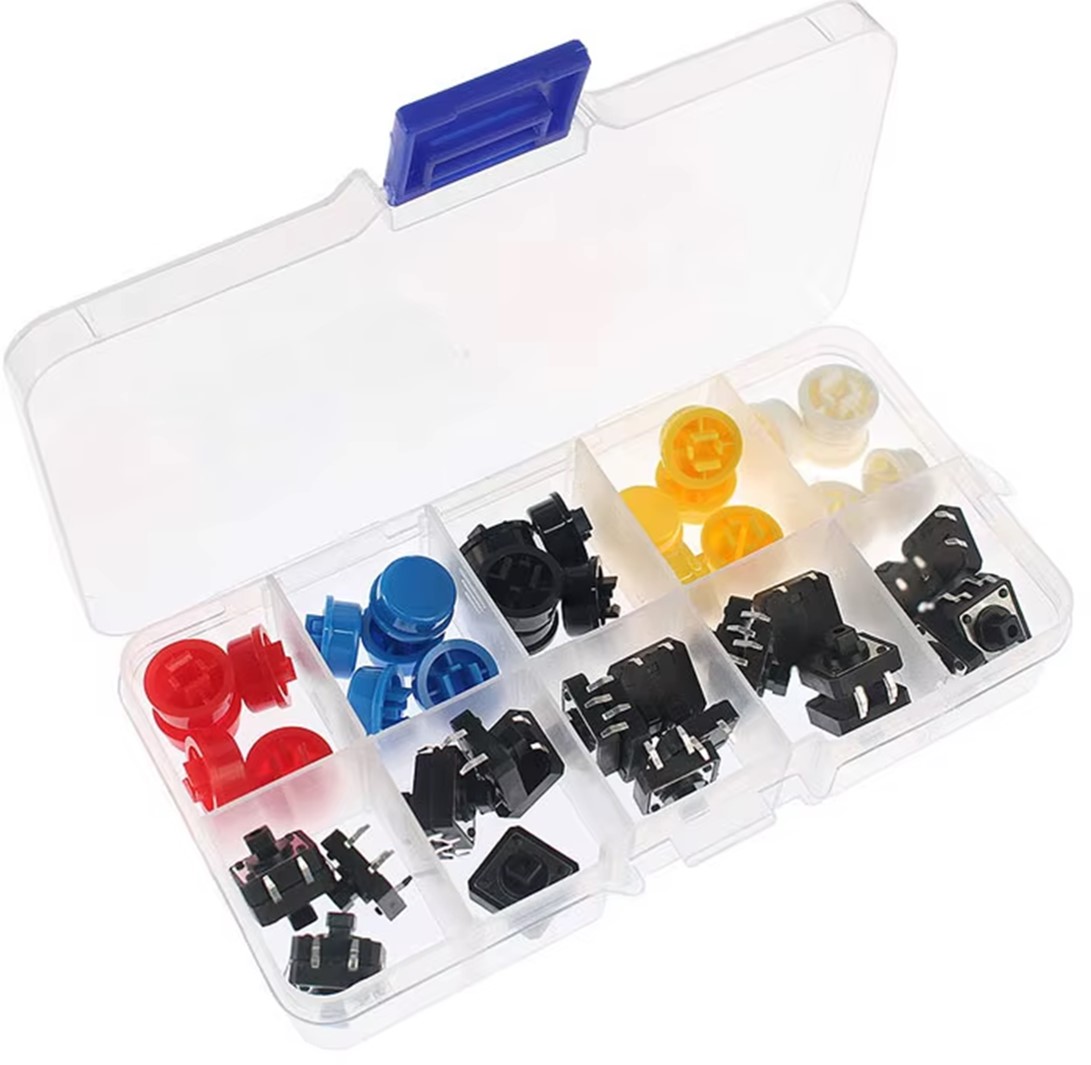 Compartmented plastic storage box open showing button caps and tactile switches sorted by color