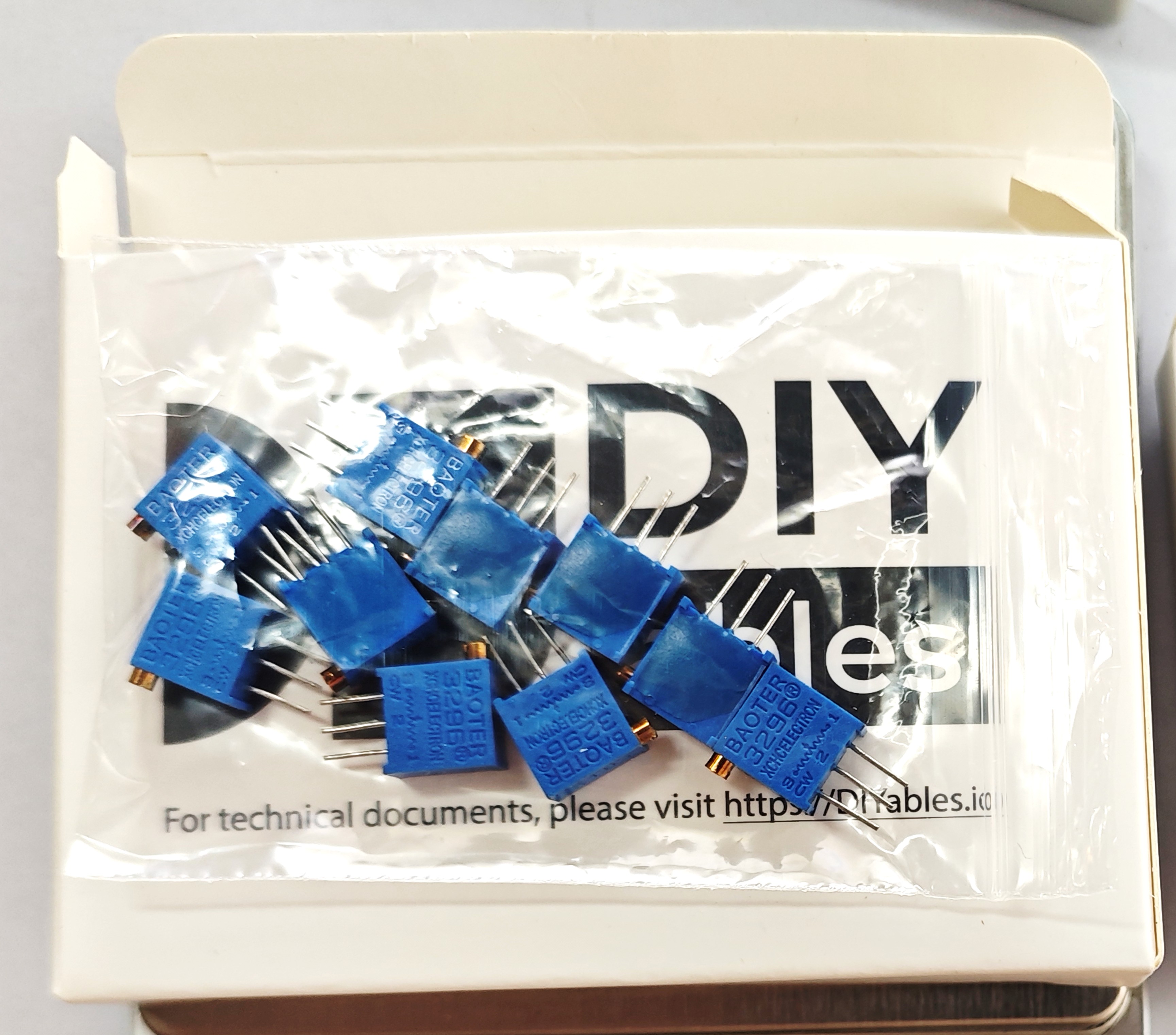 Ten 10k ohm trimmer potentiometers supplied loose in a DIYables resealable bag