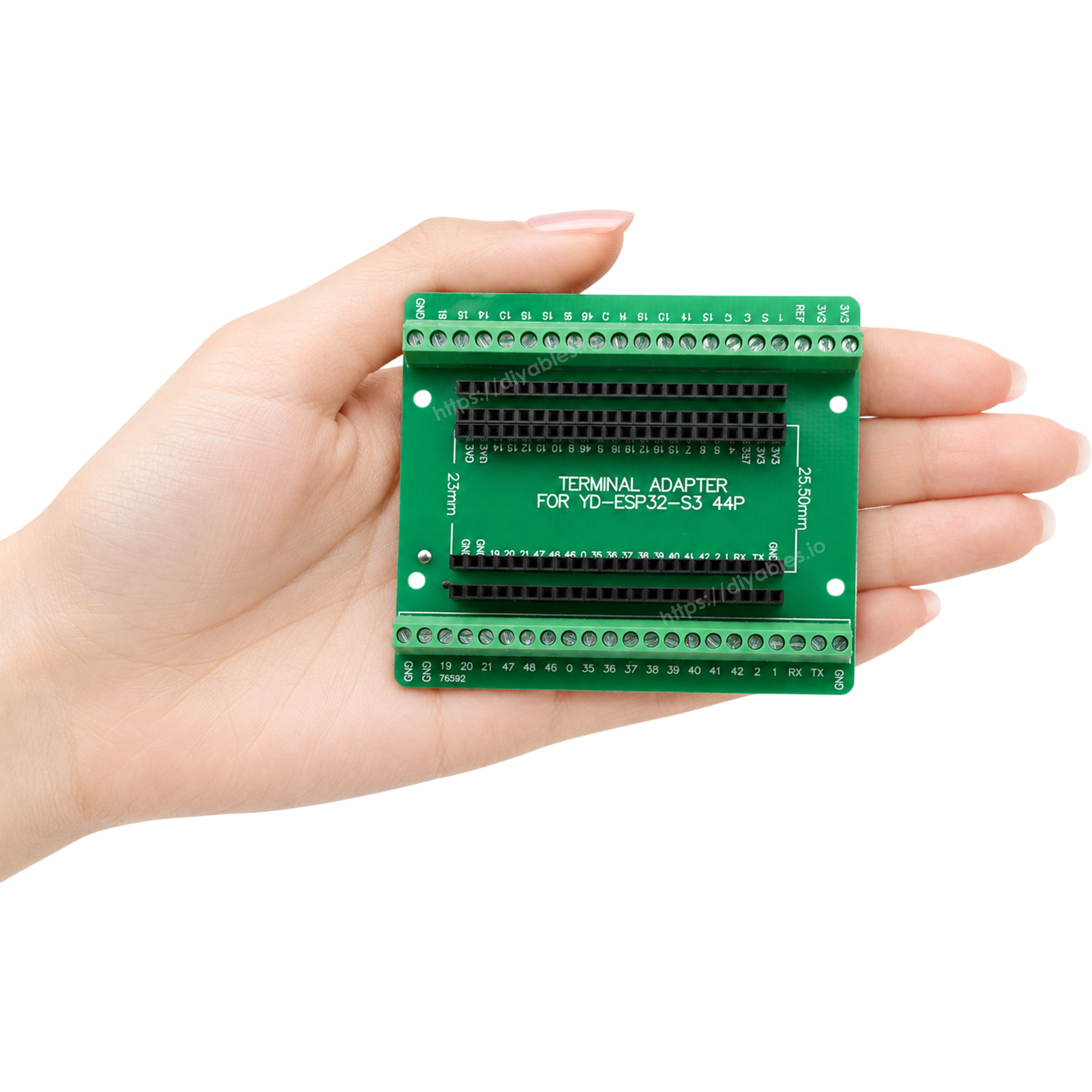 Hand holding the ESP32-S3 screw terminal adapter showing its compact palm sized footprint