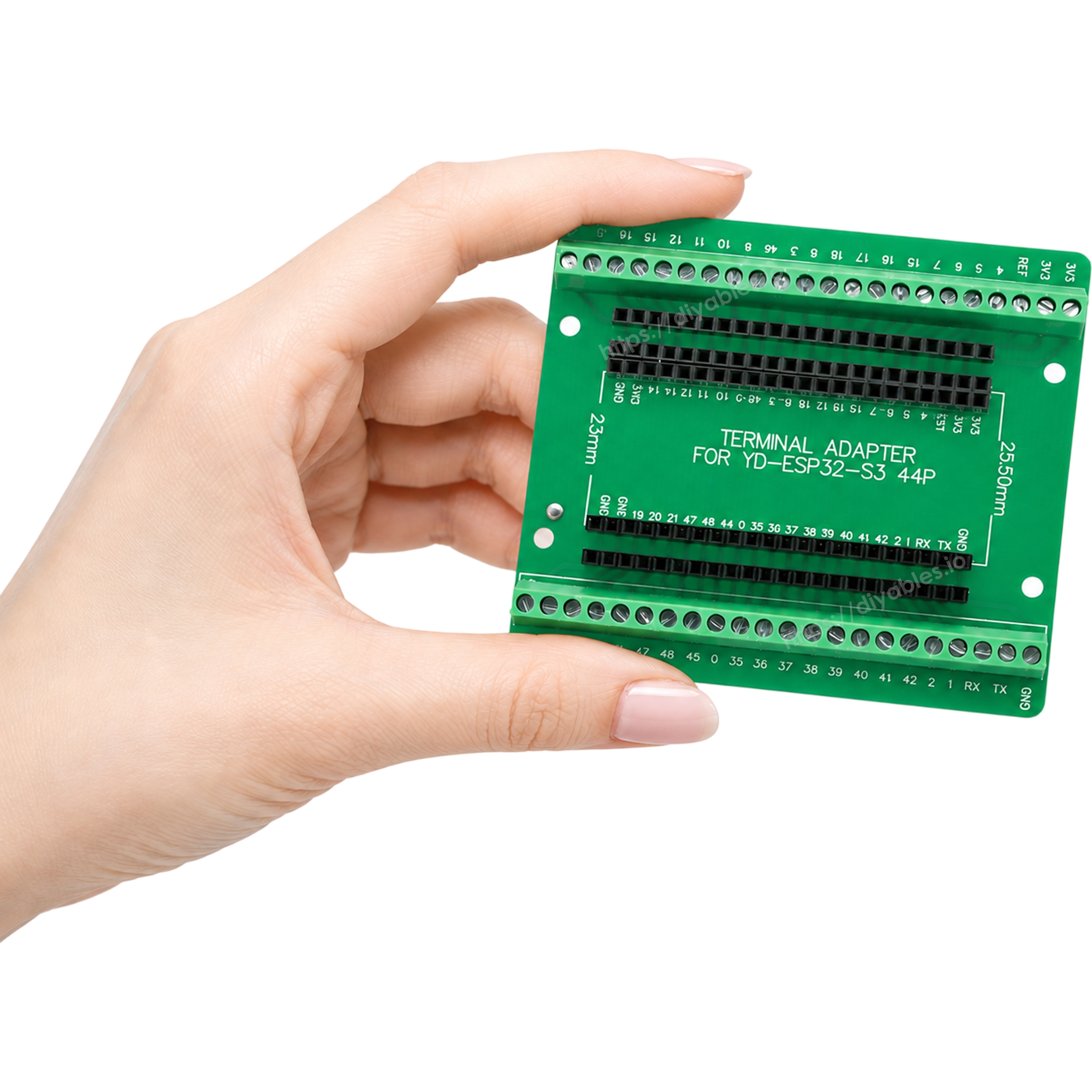 Hand holding the screw terminal adapter at an angle showing board thickness and terminal rows